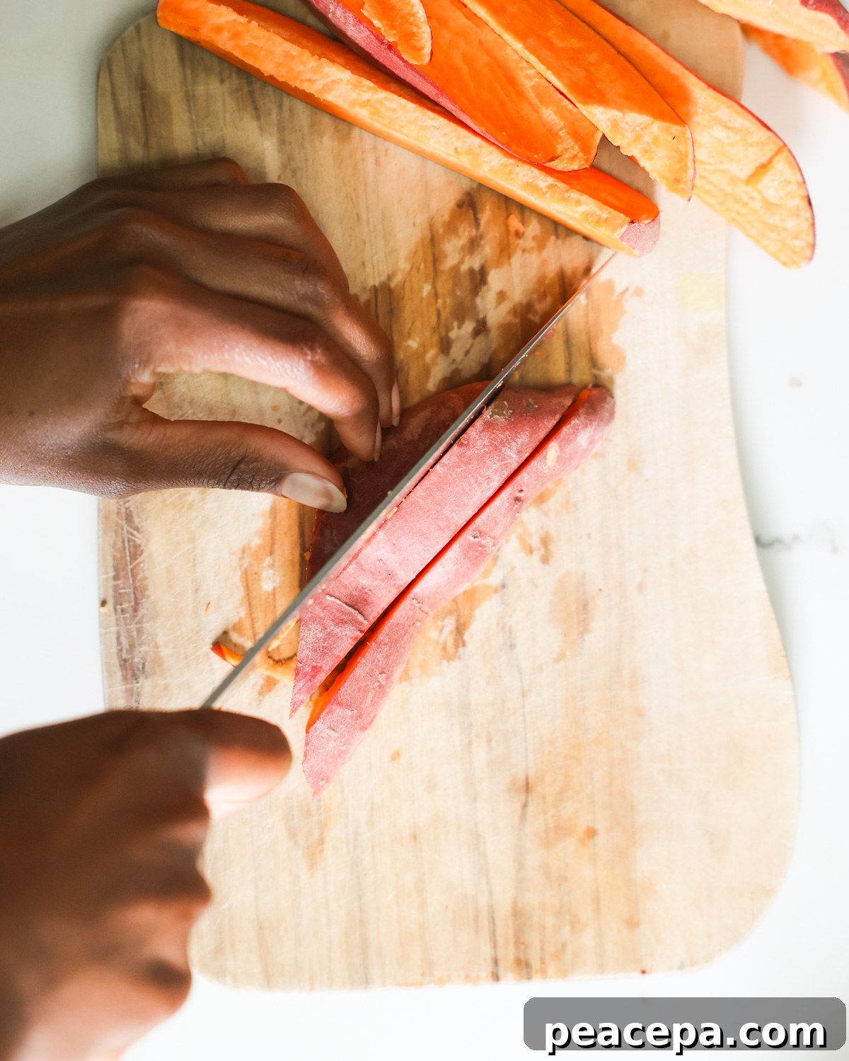 Cutting sweet potatoes into wedge shape