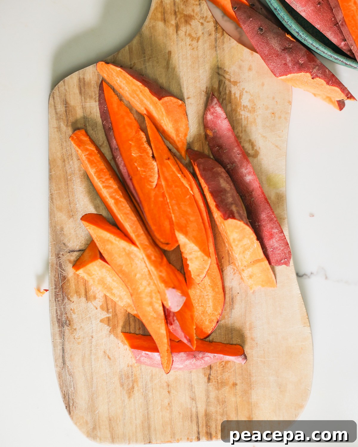 sliced sweet potatoes on a cutting board