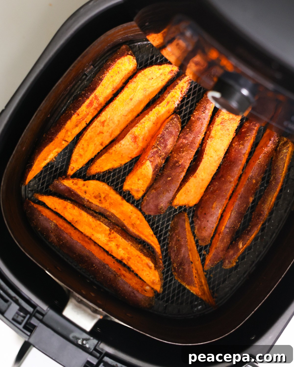 overhead of air fryer sweet potato wedges in air fryer