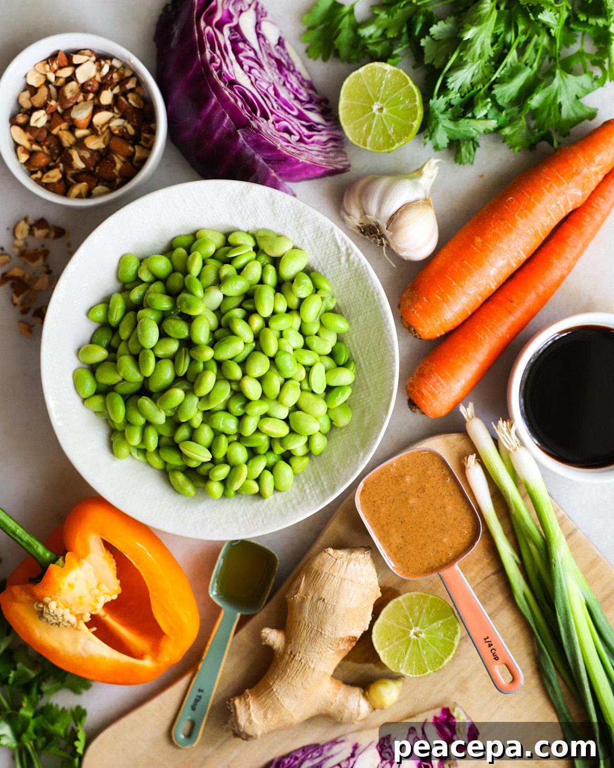 All of the ingredients to make edamame salad on the counter.