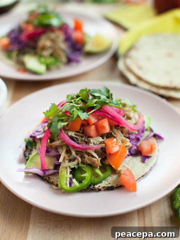 mushroom carnitas tacos on a light pink plate