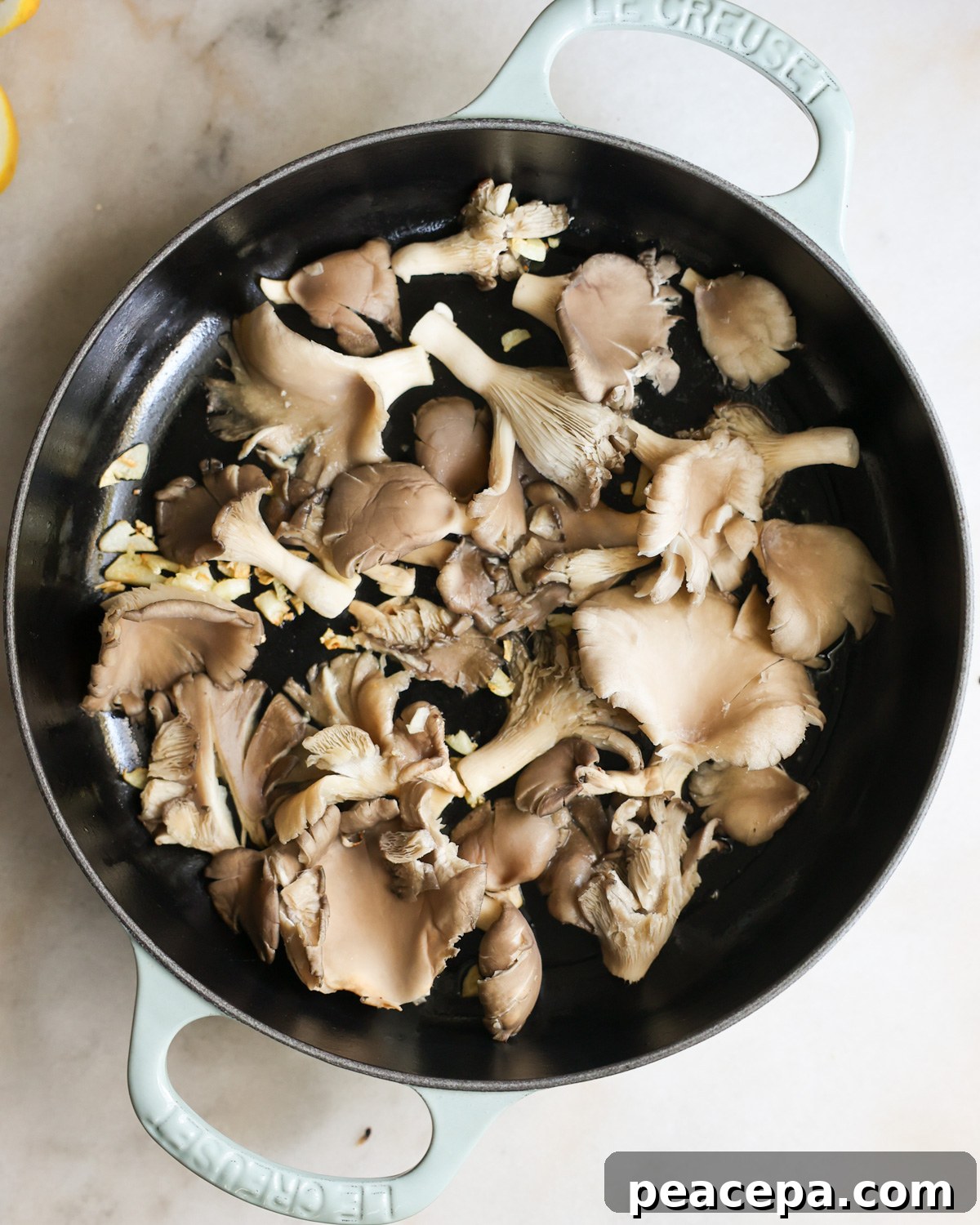 overhead of oyster mushrooms in a skillet