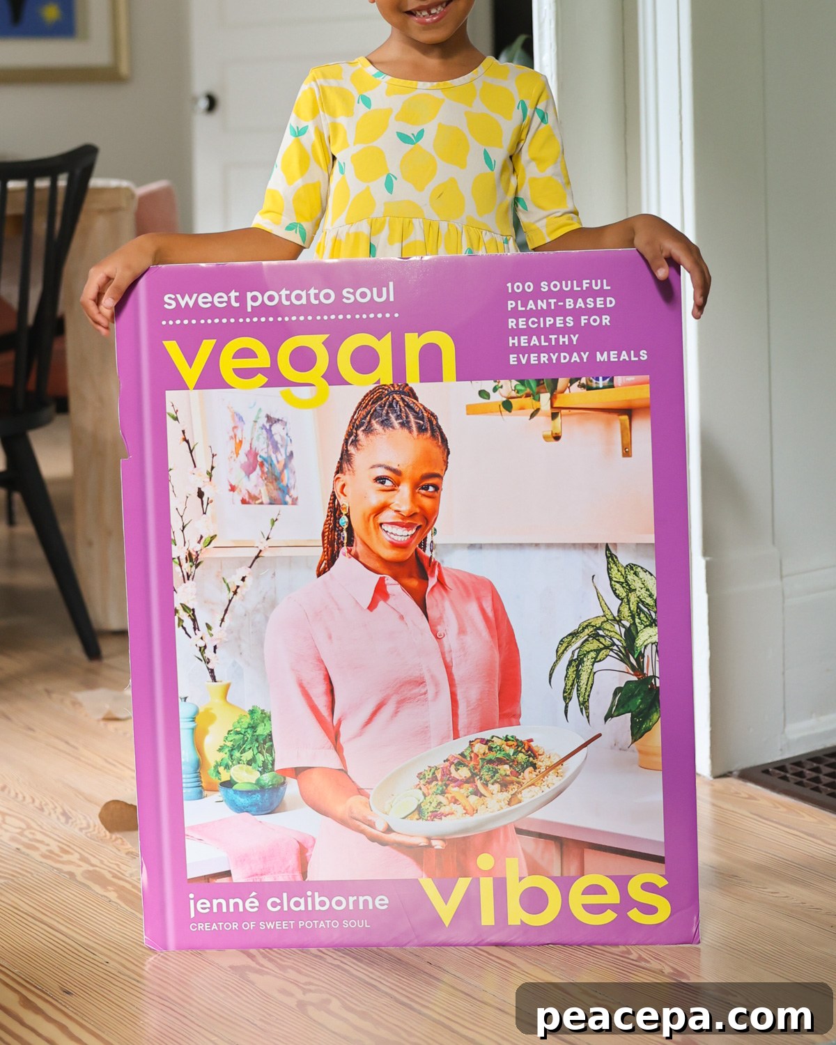 baby holding cookbook poster