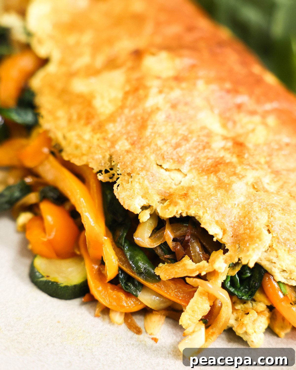 close up vegan omelette stuffed with vegetables