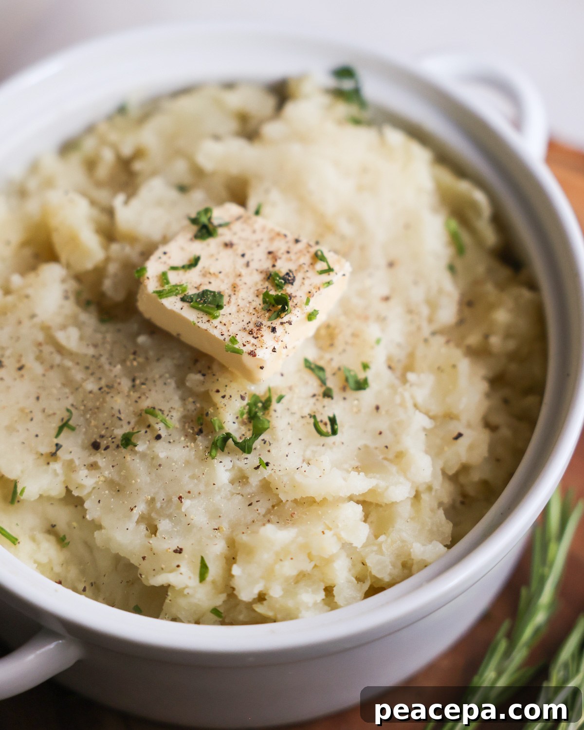 close up of vegan mashed potatoes in a white bowl.