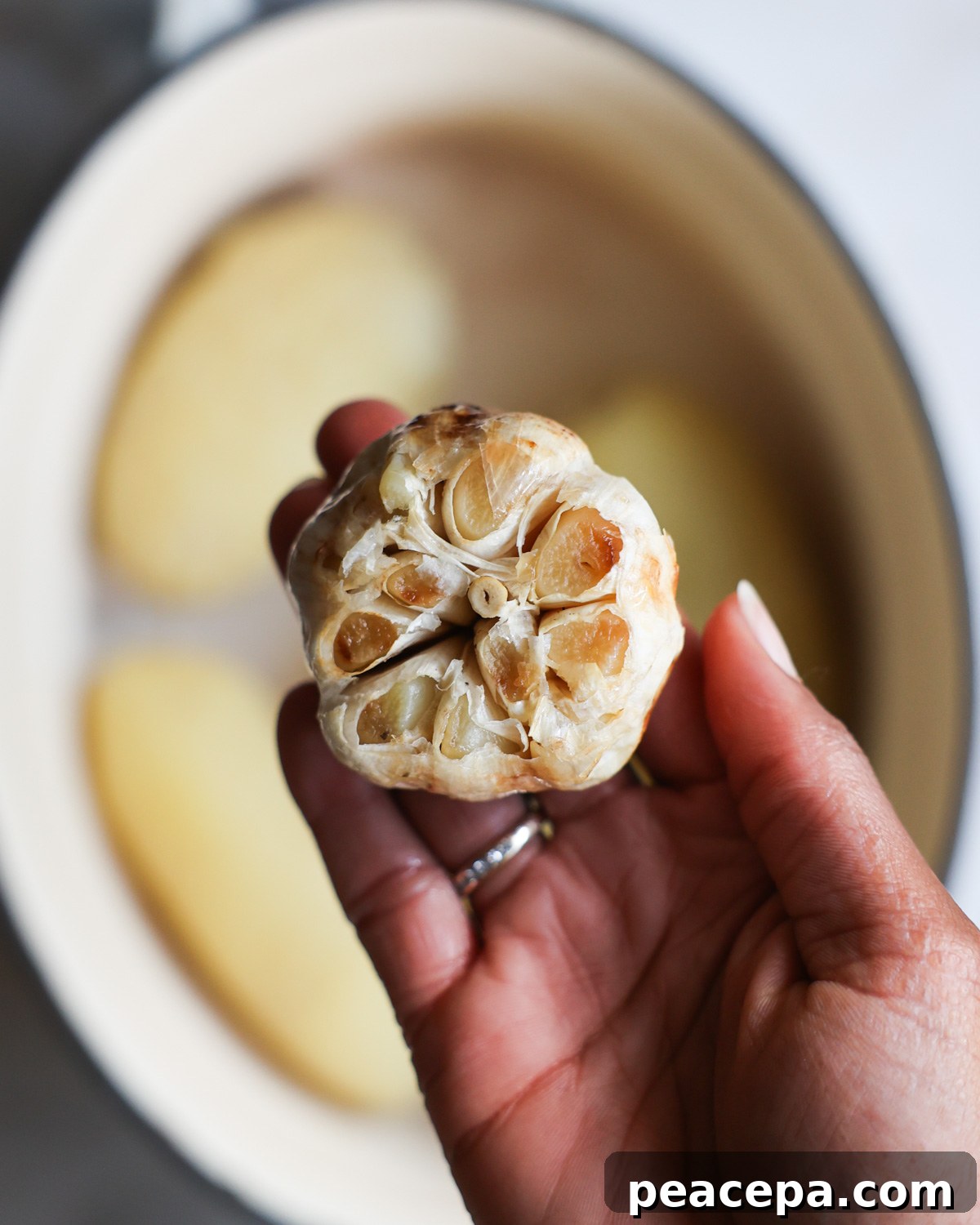 tender roasted garlic in Jenné's hand