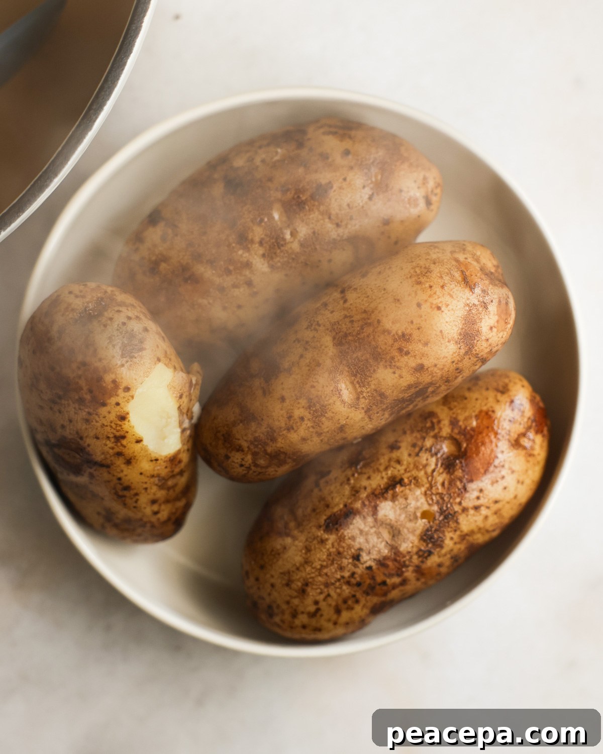 overhead of cooked potatoes cooling in a dish