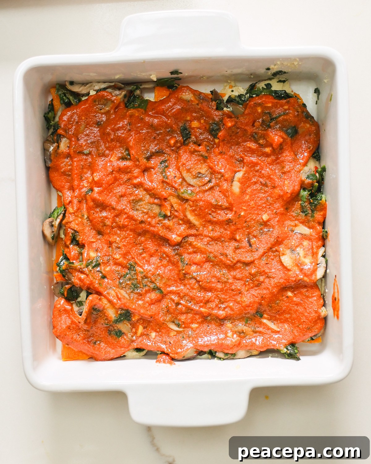 tomato sauce layered on butternut squash lasagna
