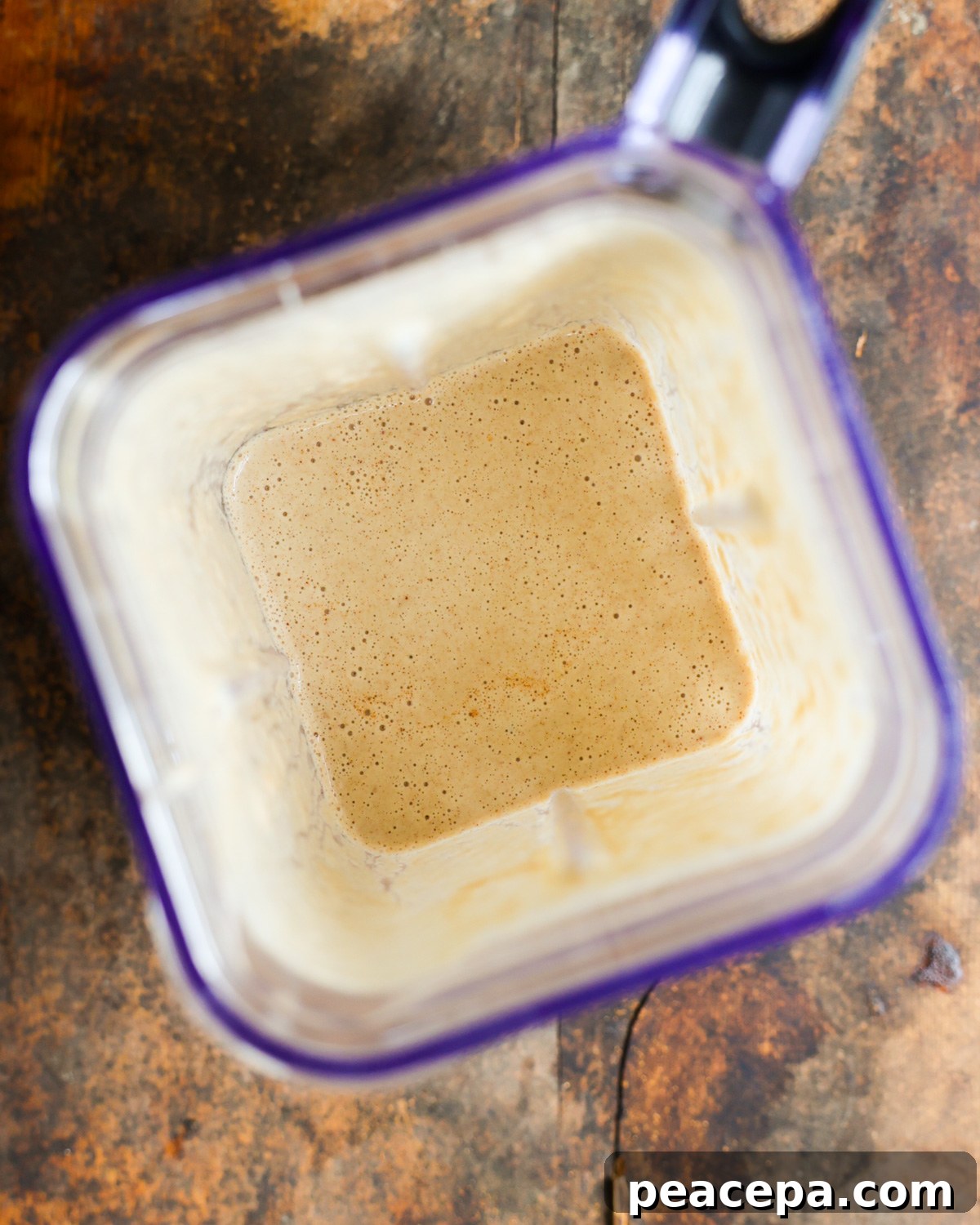 overhead of blended apple smoothie in blender