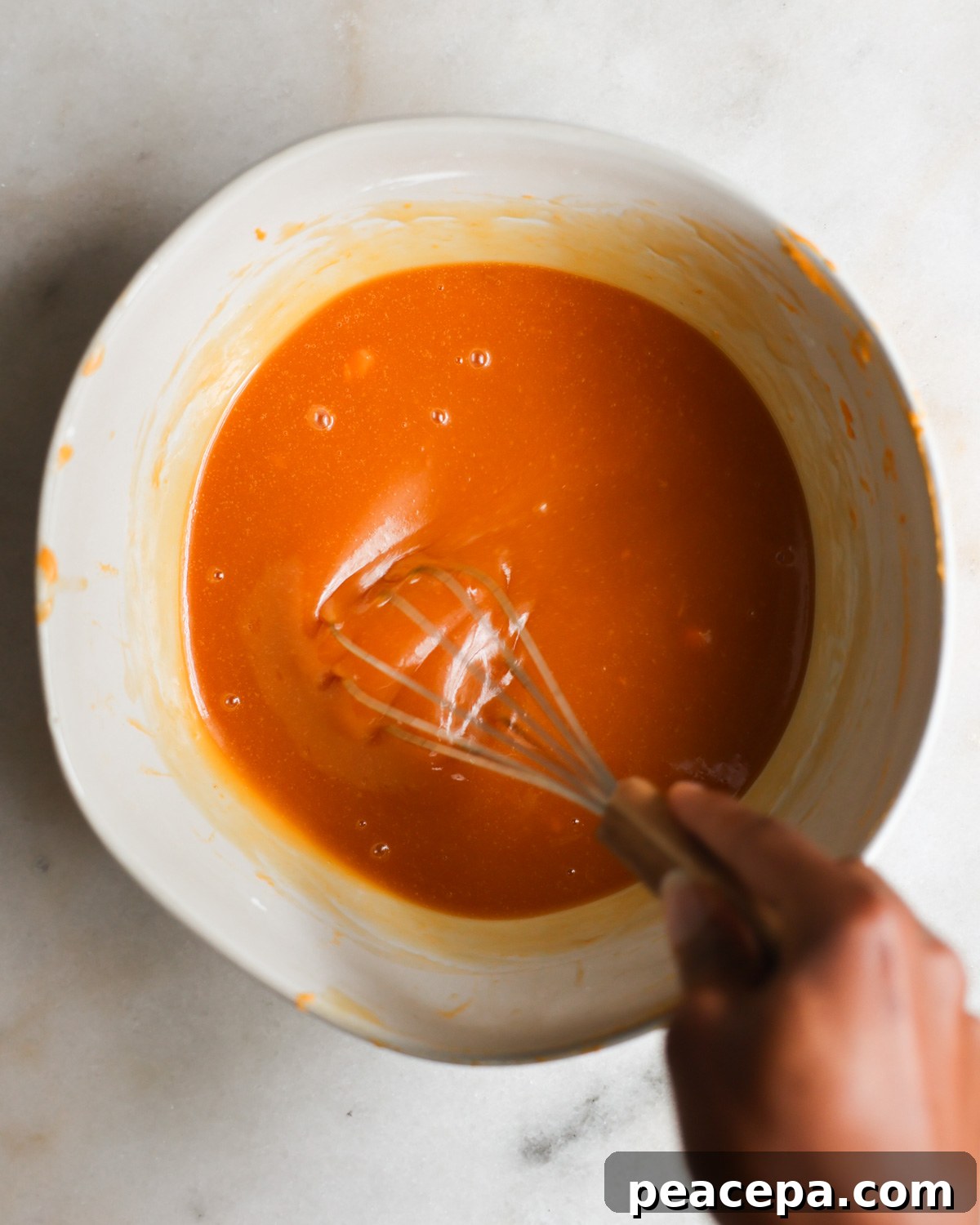 overhead of whisking sweet potato filling