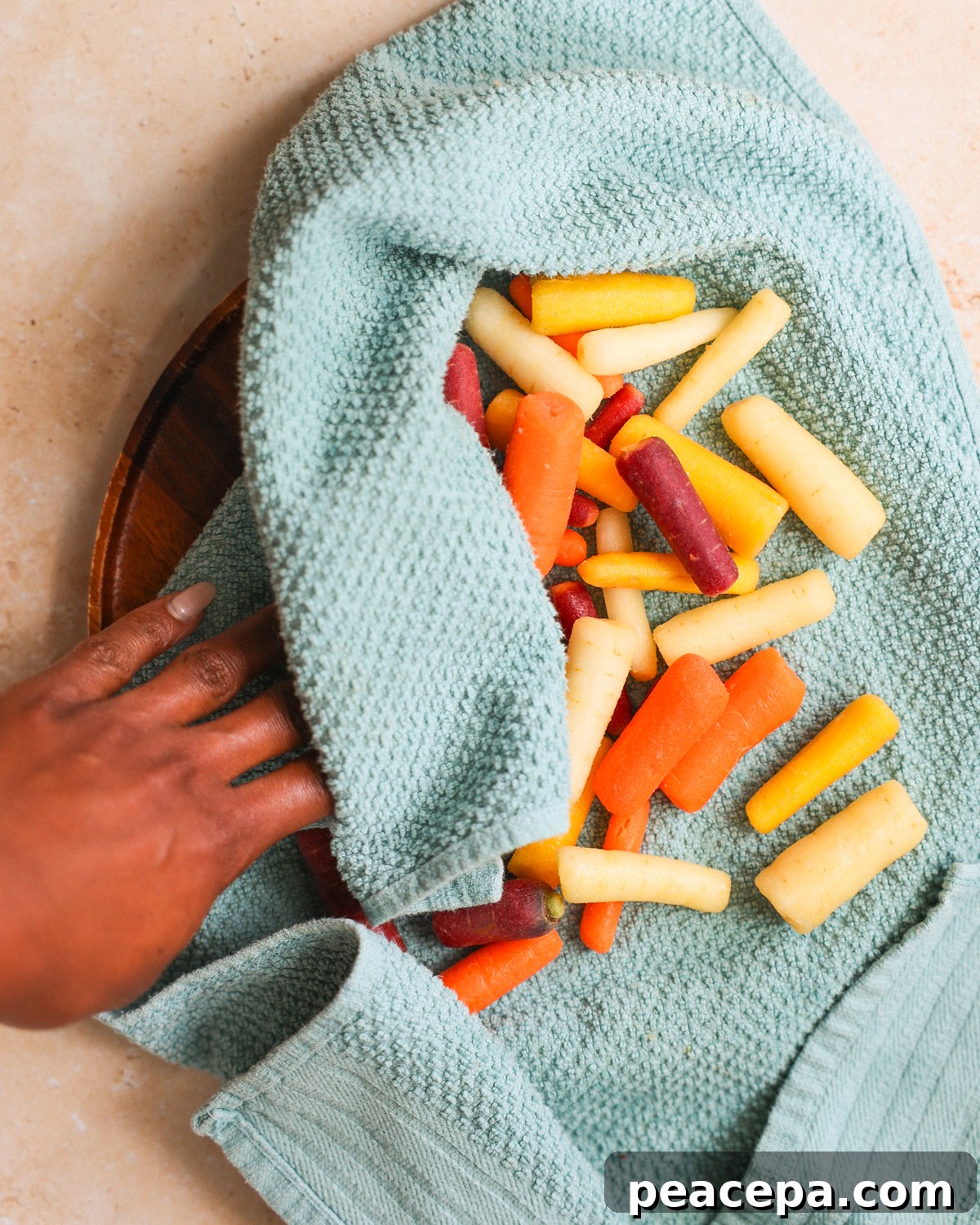 drying baby carrots with a towel
