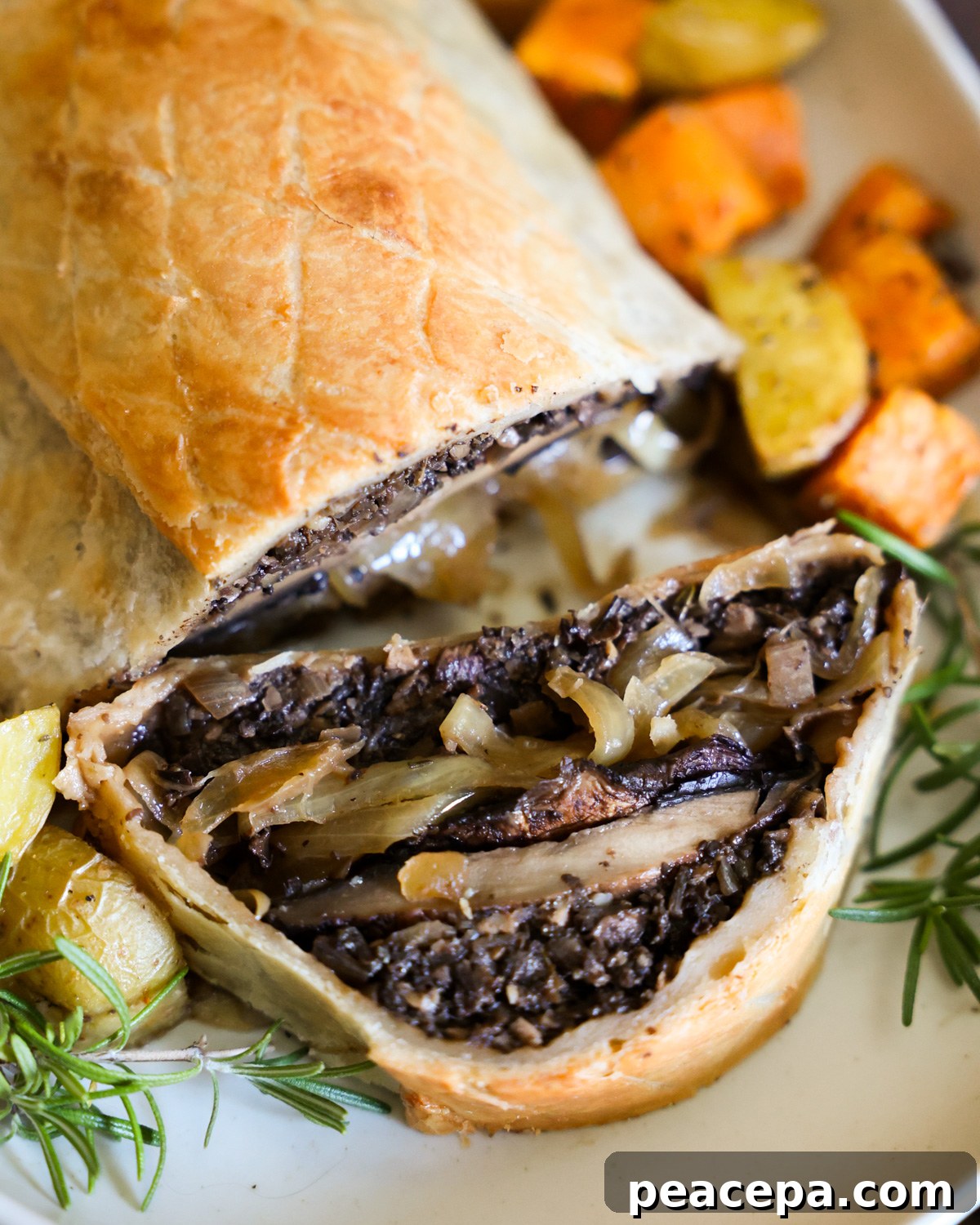 A close up shot of the baked mushroom Wellington with a slice taken out of it.