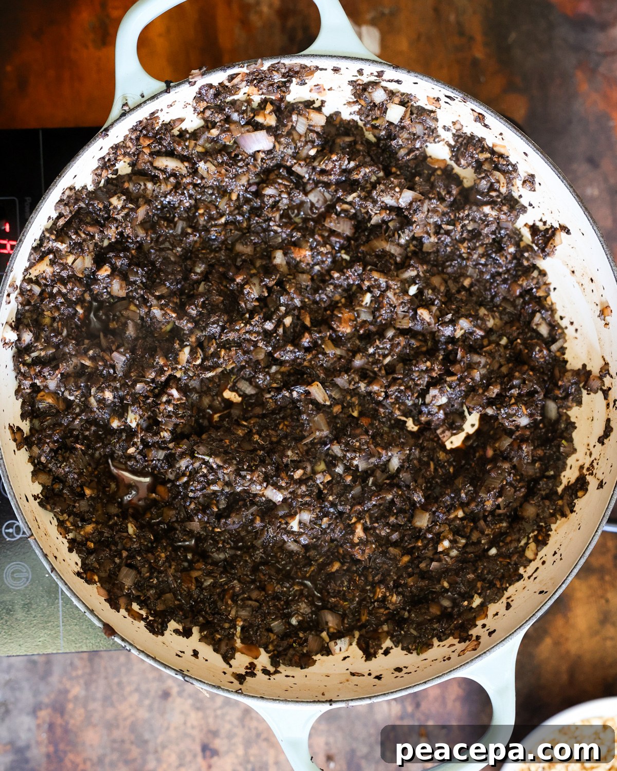 An overhead shot of the cooked mushroom filling in a pan.