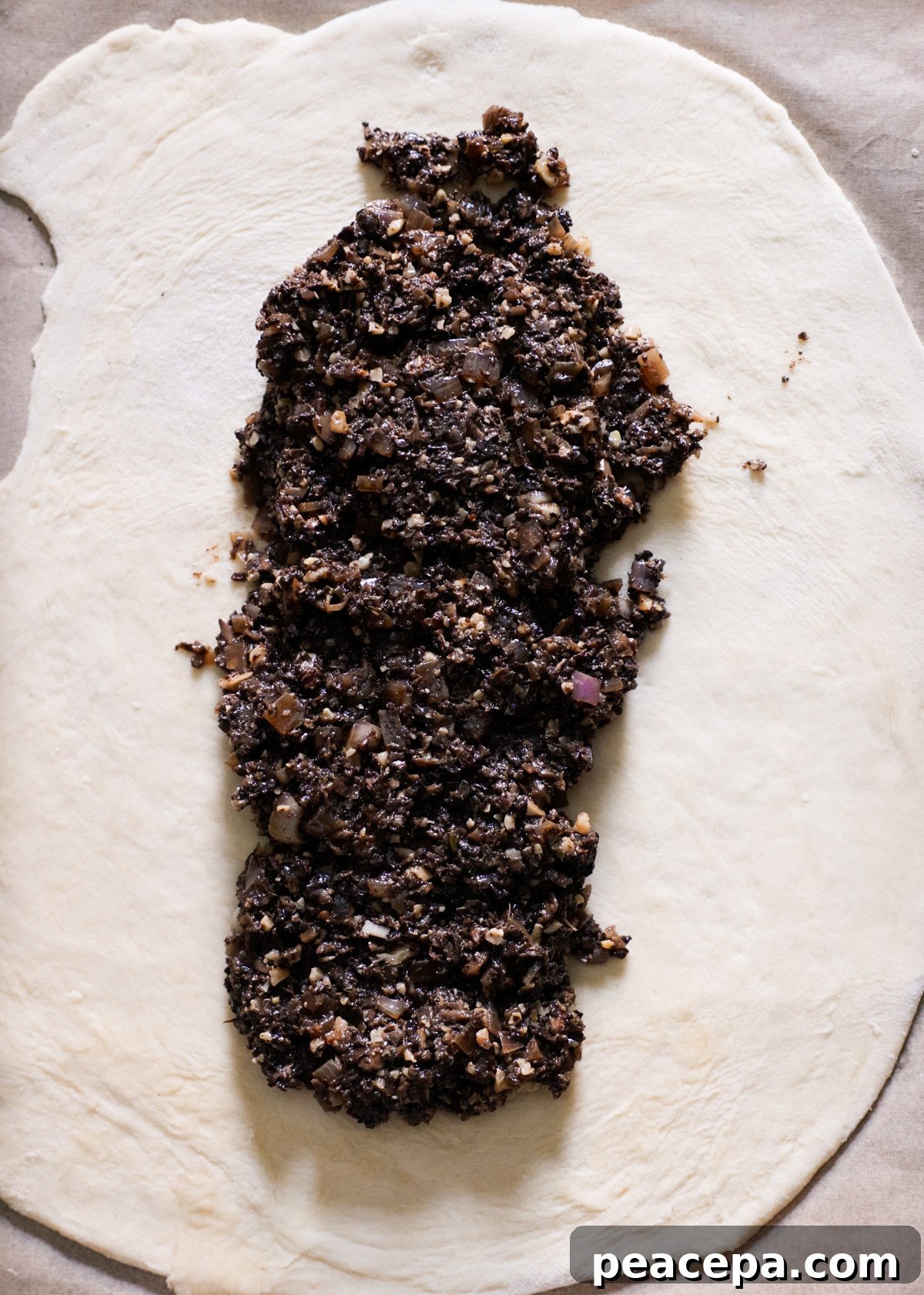 The mushroom filling spread down the center of the rolled pastry.