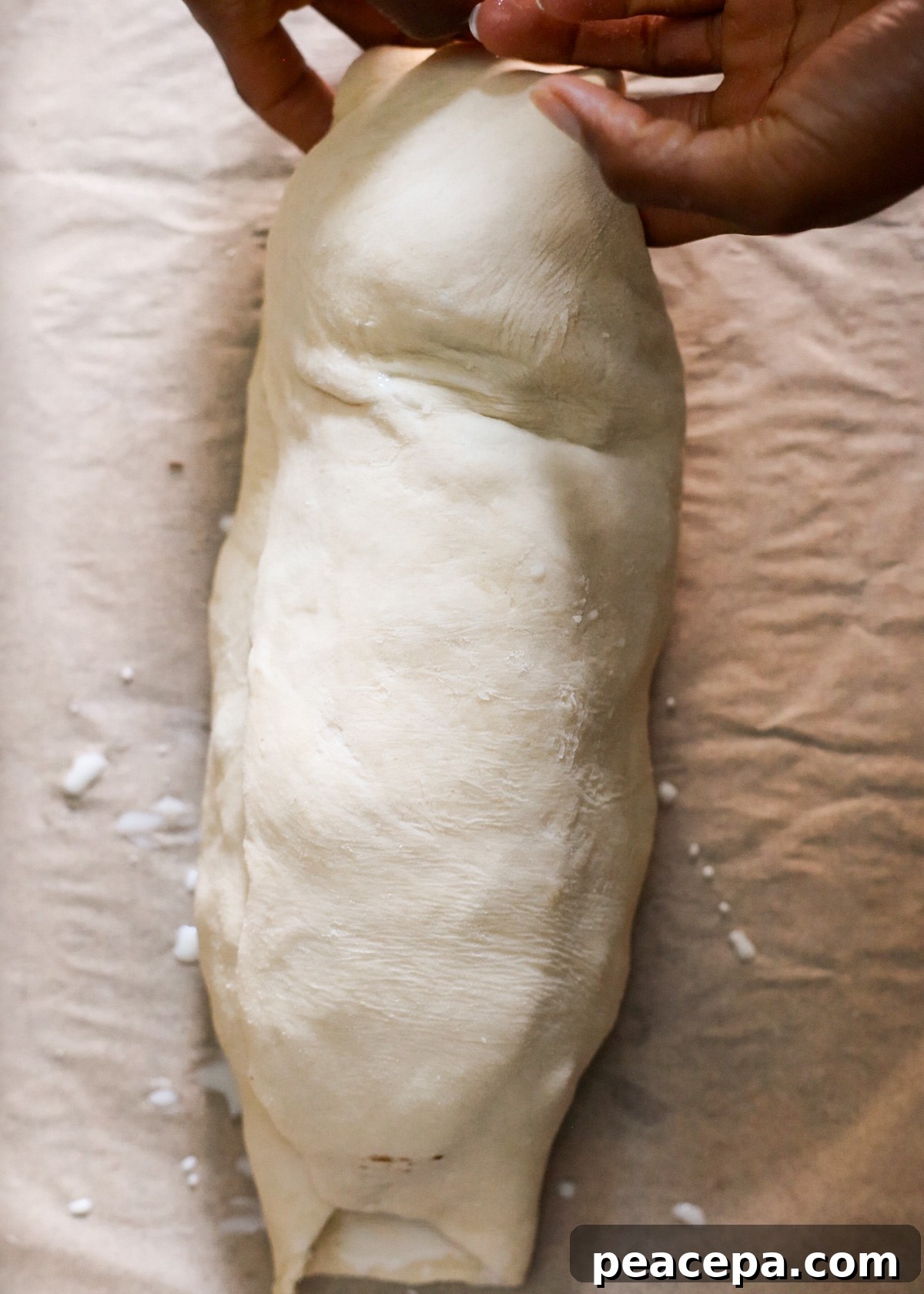 Turning the pastry ends under the mushroom Wellington.