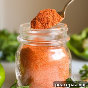 scoop of creole seasoning in a jar