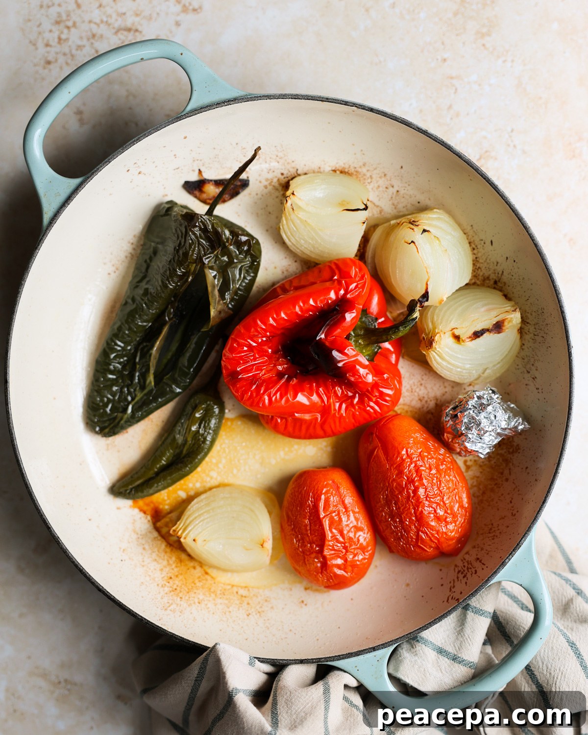 Roasted peppers and tomatoes in the skillet.