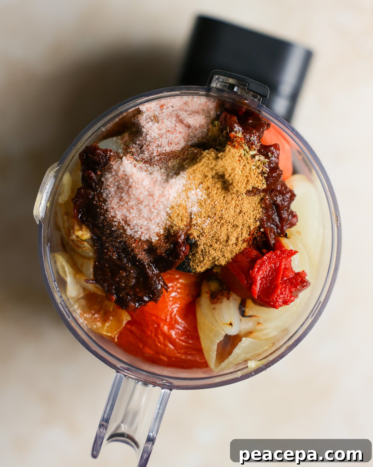 Sofrito sauce ingredients in a food processor.