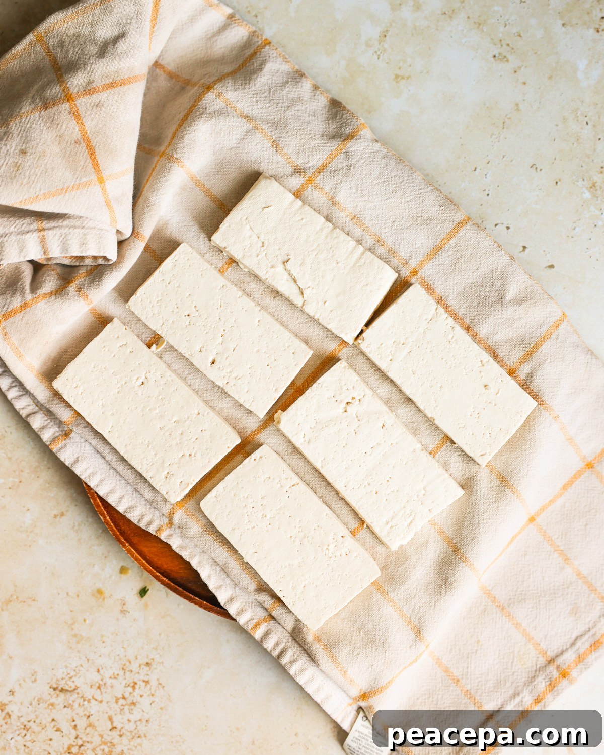 tofu on towel before pressing