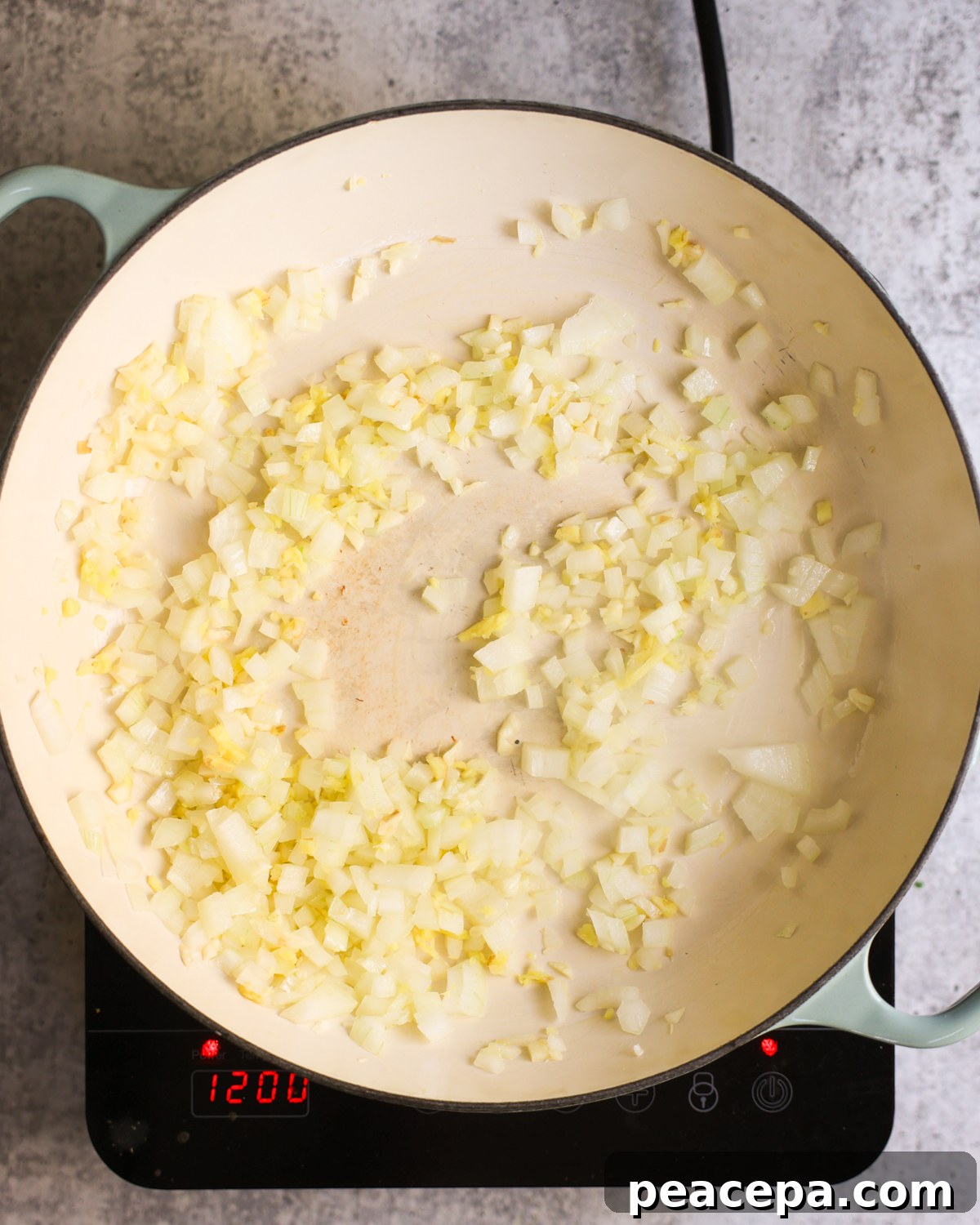 Sautéing aromatics in a skillet.