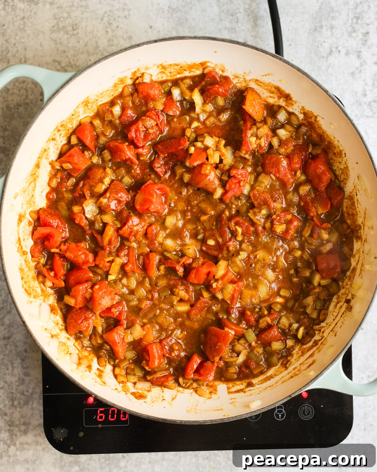 Tomatoes cooking in pan.