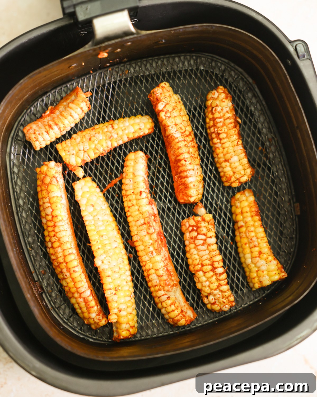 corn arranged in air fryer