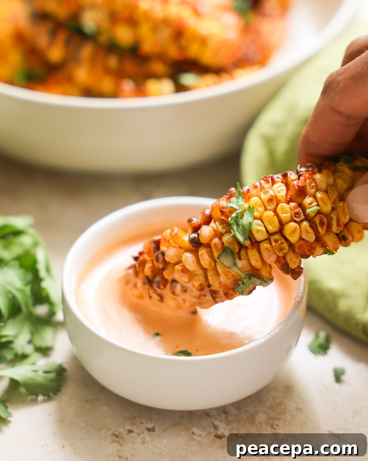 dipping corn ribs in aioli