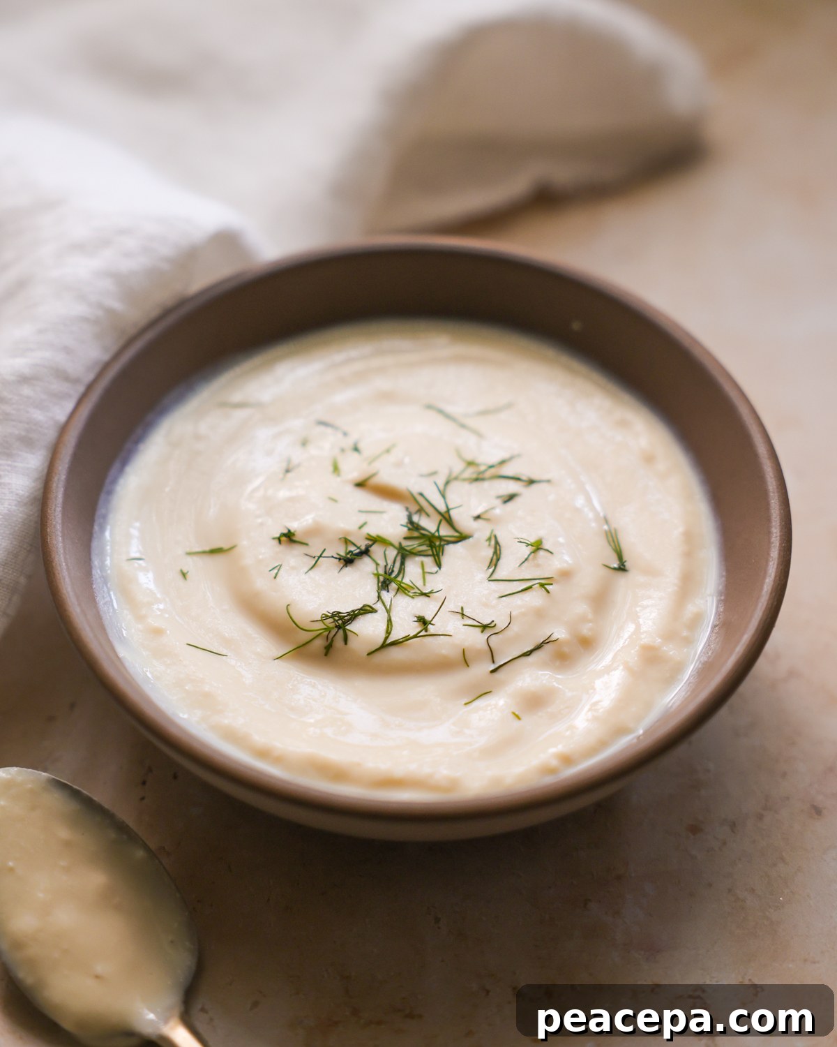 vegan sour cream in a bowl topped with dill
