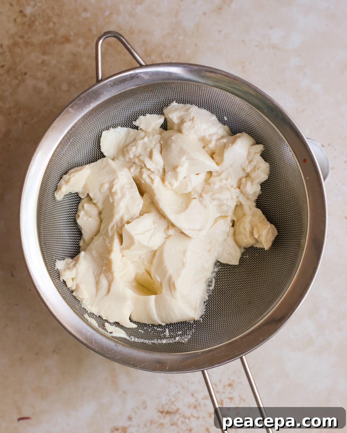 silken tofu draining into bowl