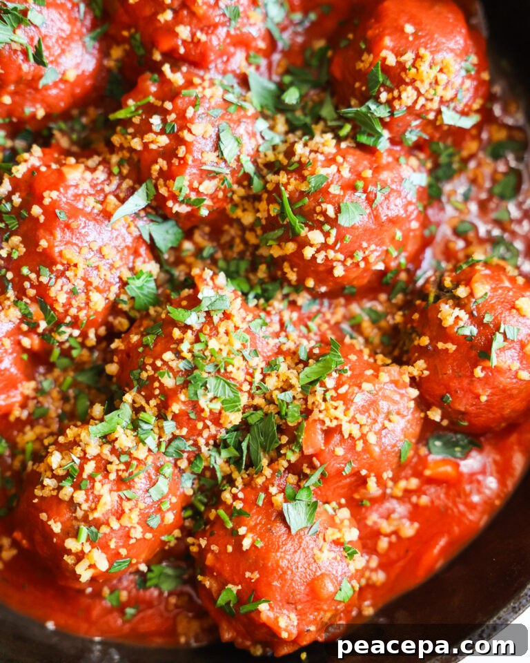 Lentil vegan meatballs covered in tomato sauce.