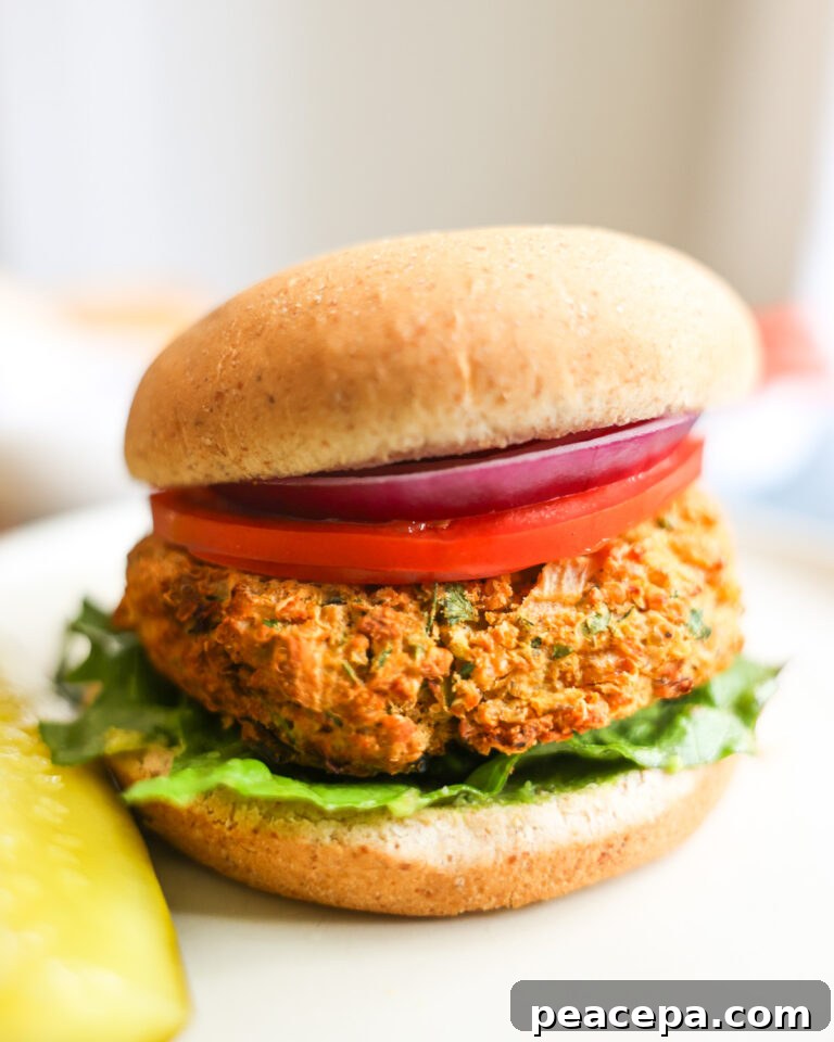 side view of quinoa zucchini burger with a pickle
