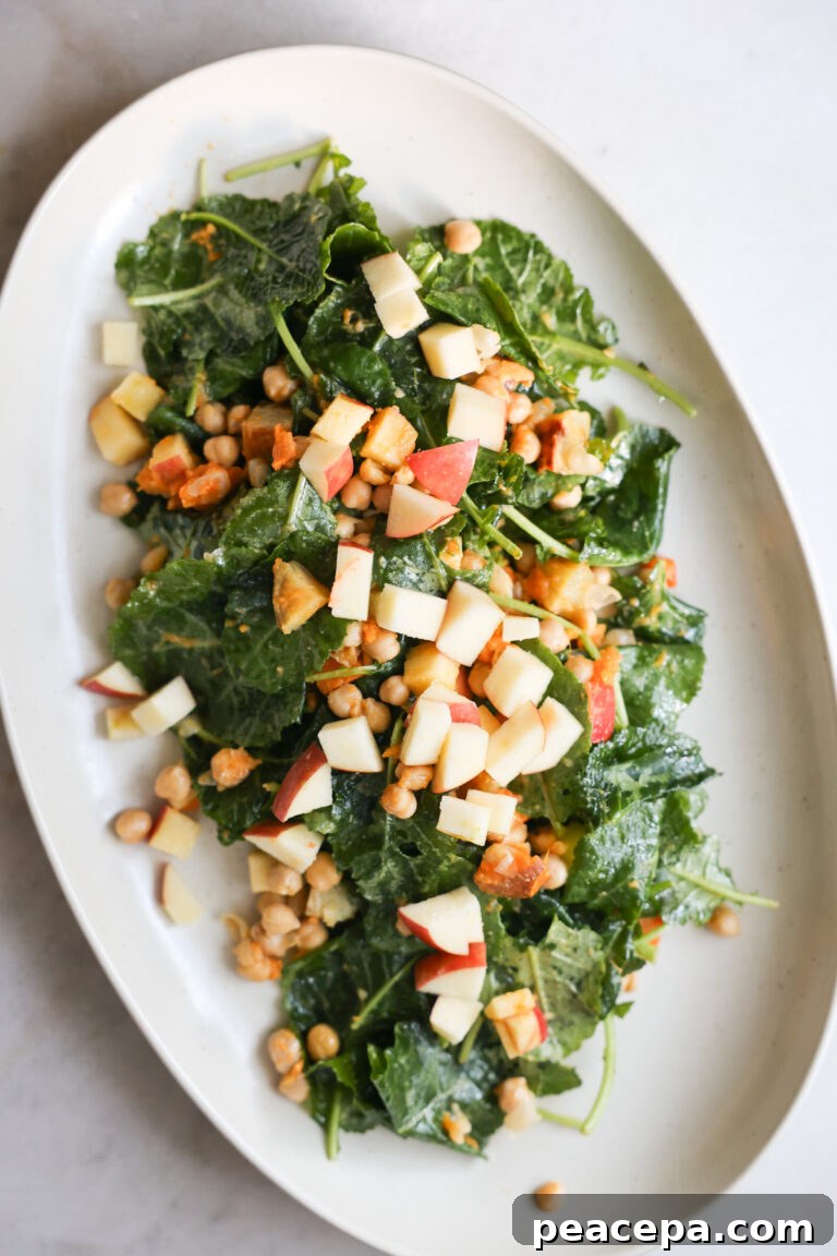 overhead of baby kale salad on white platter