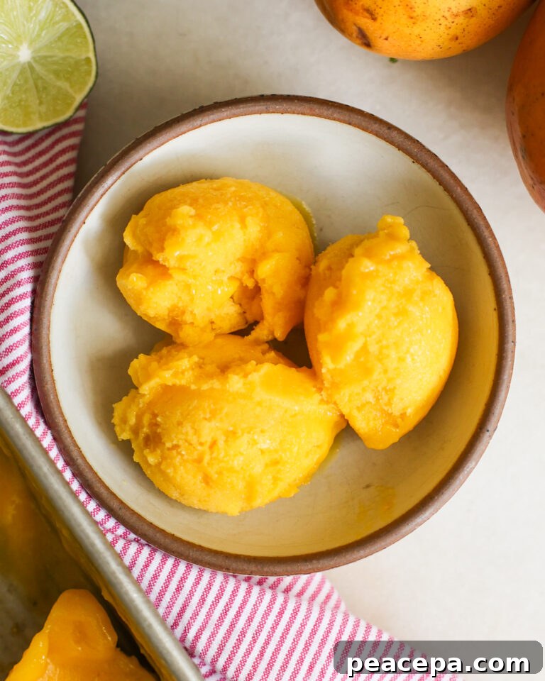 overhead of mango sorbet scoops in a bowl