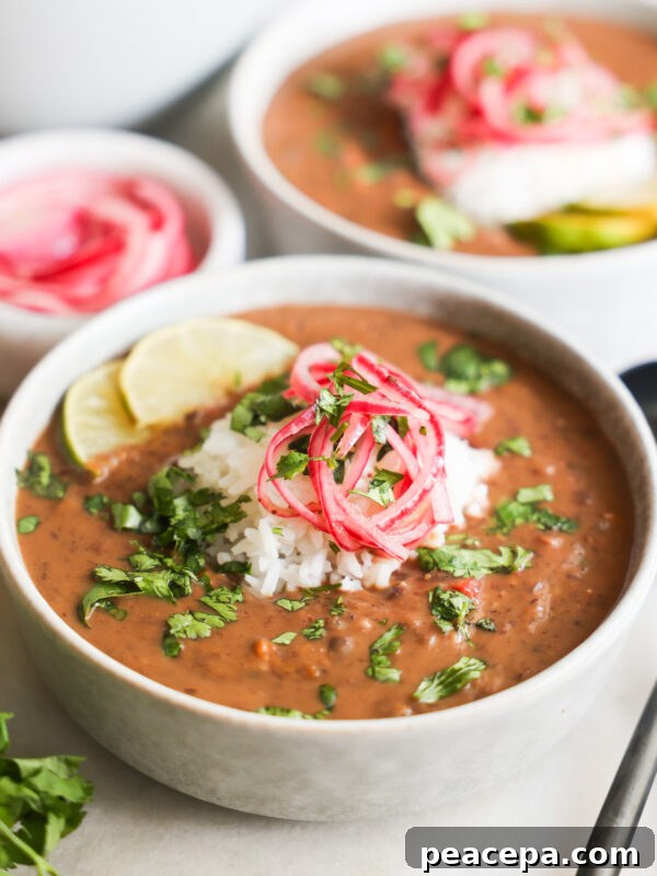 Black bean soup topped with colorful garnish.
