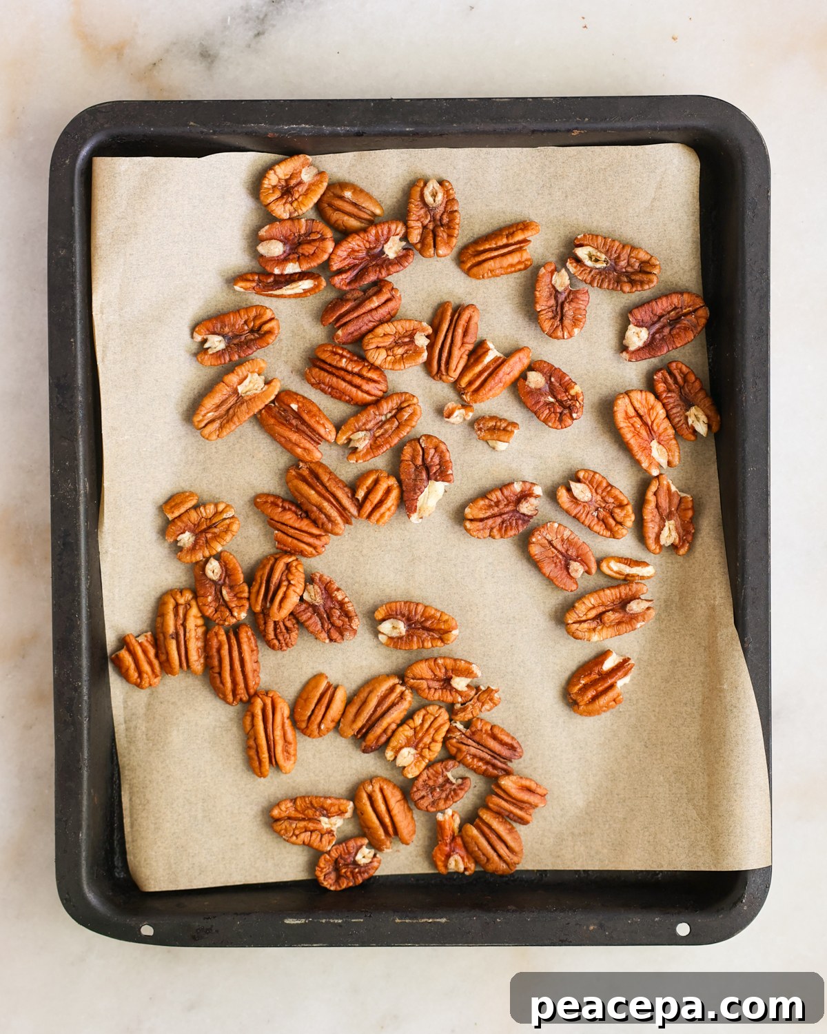 overhead raw nuts on baking sheet