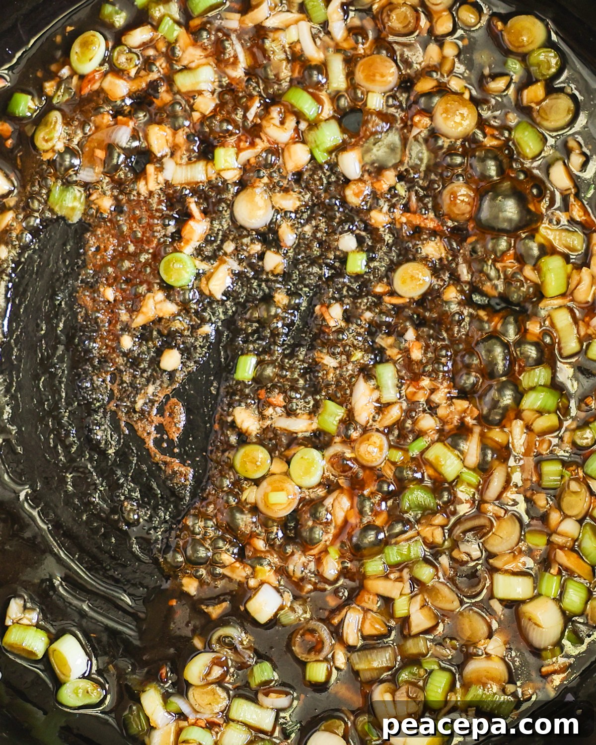 close up garlic noodle sauce simmering