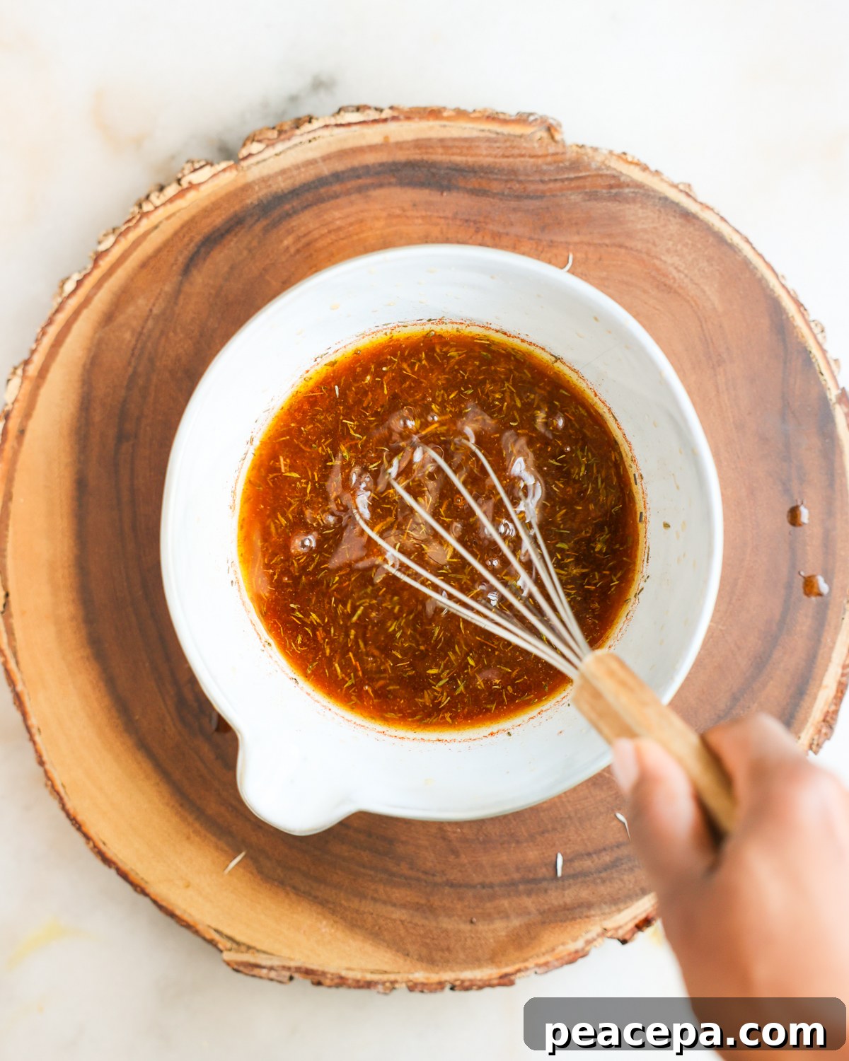 Whisking mushroom marinade in a bowl.