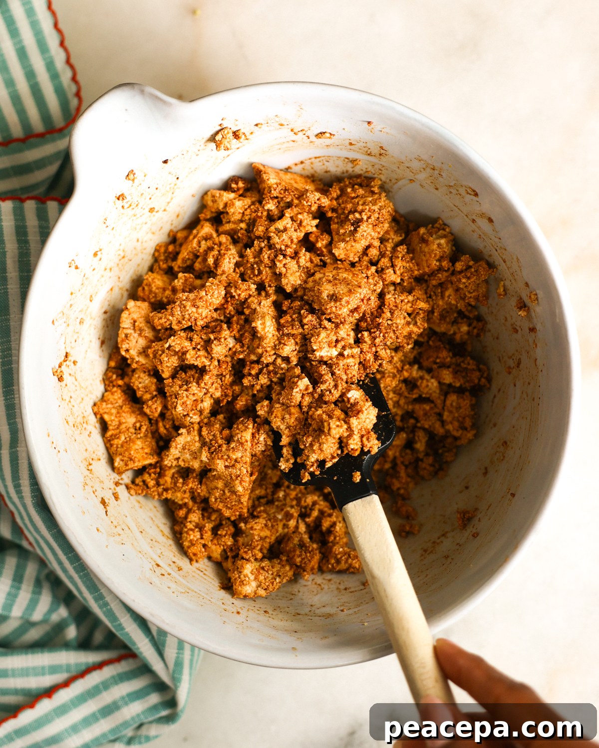 stirring spices into tofu