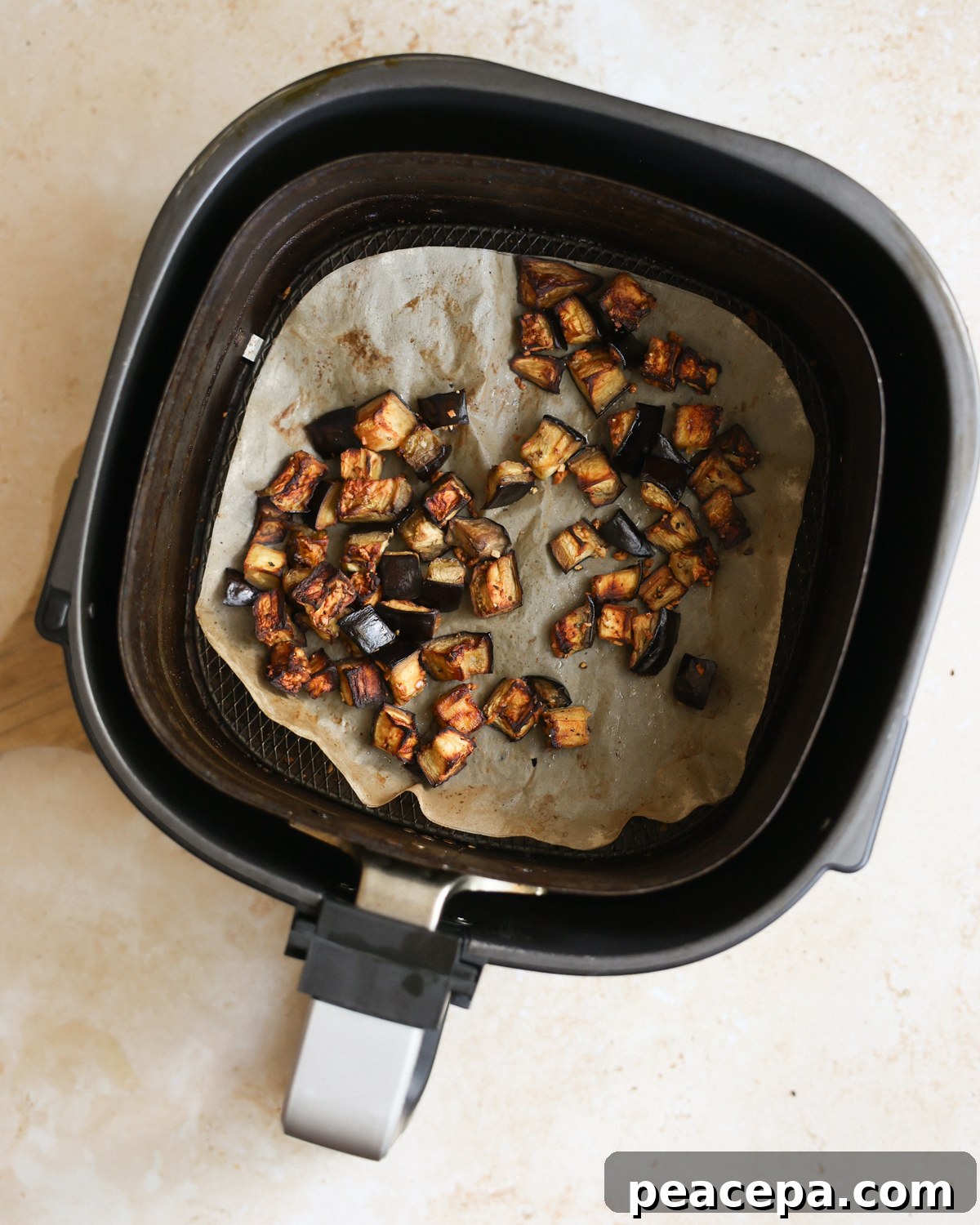 An overhead shot of the air fryer eggplant in the air fryer basket.