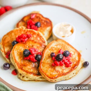 A plate of sourdough discard pancakes with berries.