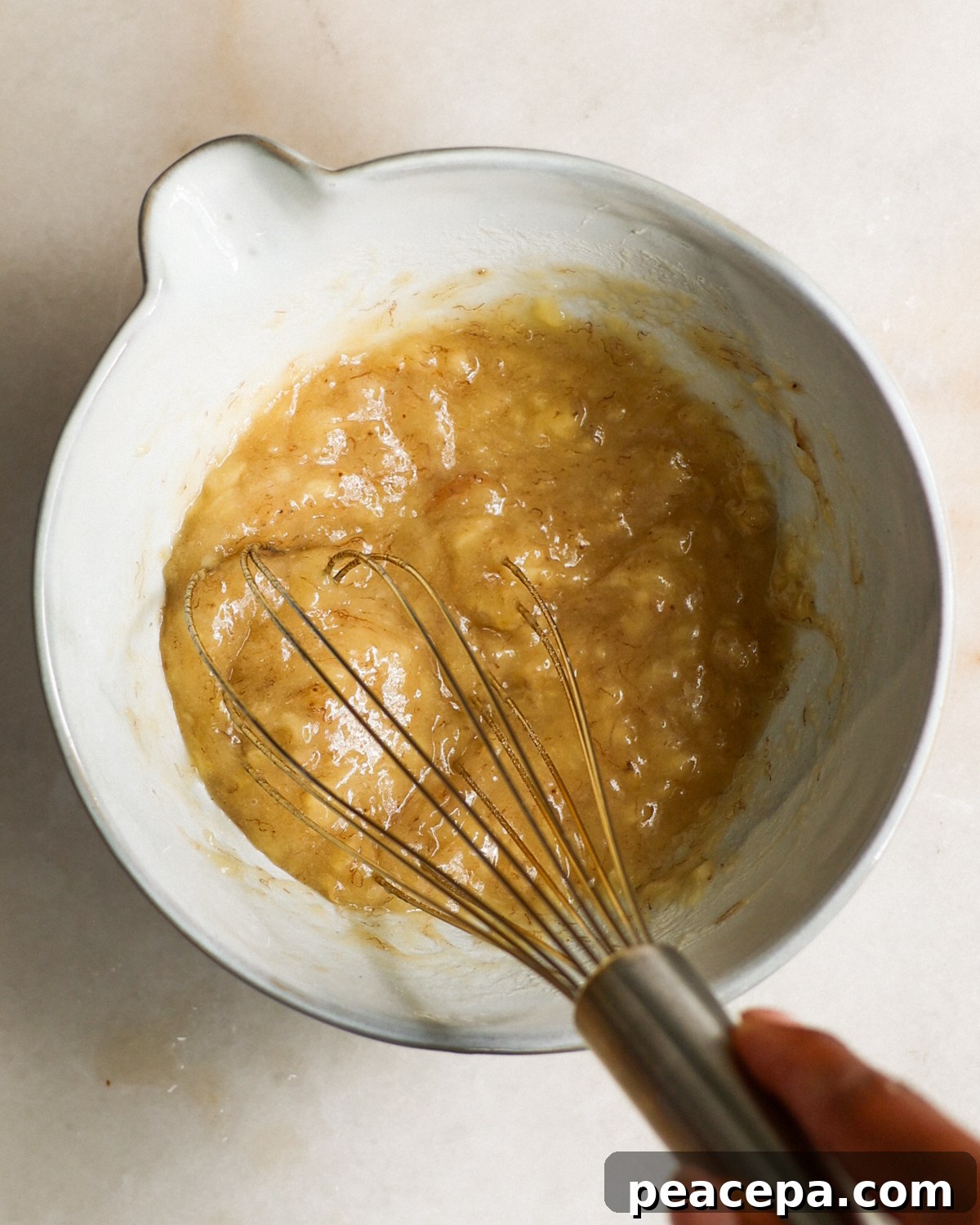 mashing ripe bananas in bowl