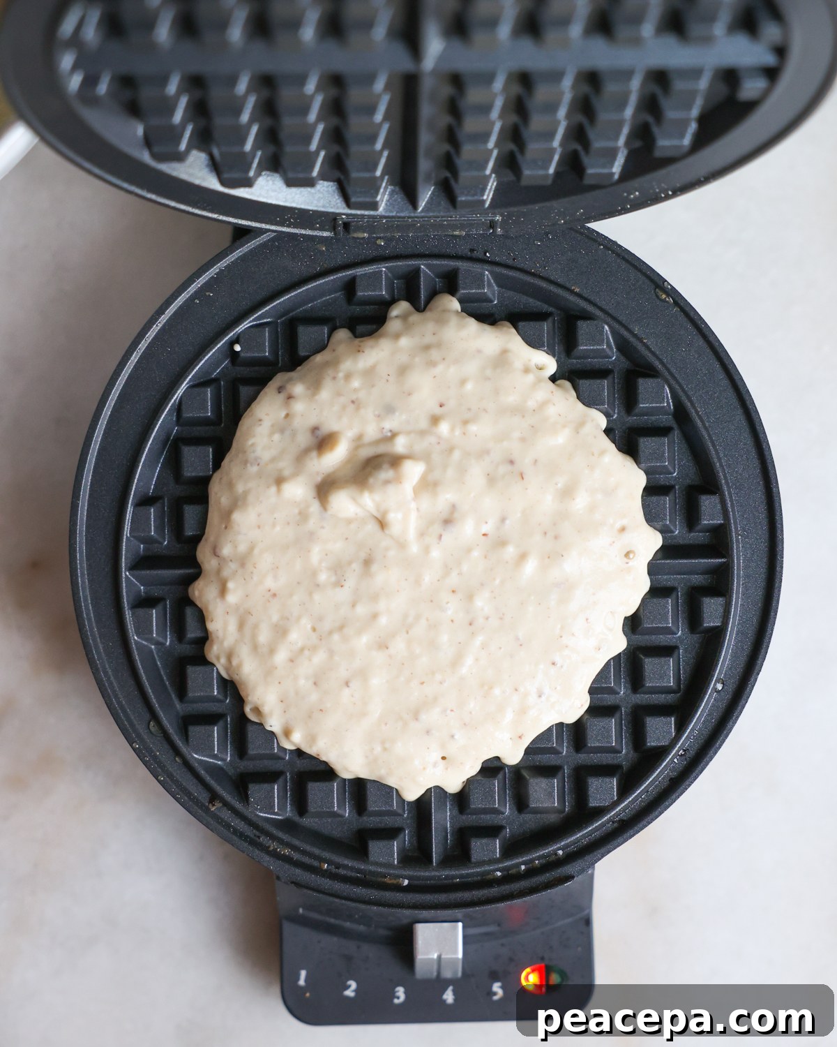 overhead batter in waffle iron