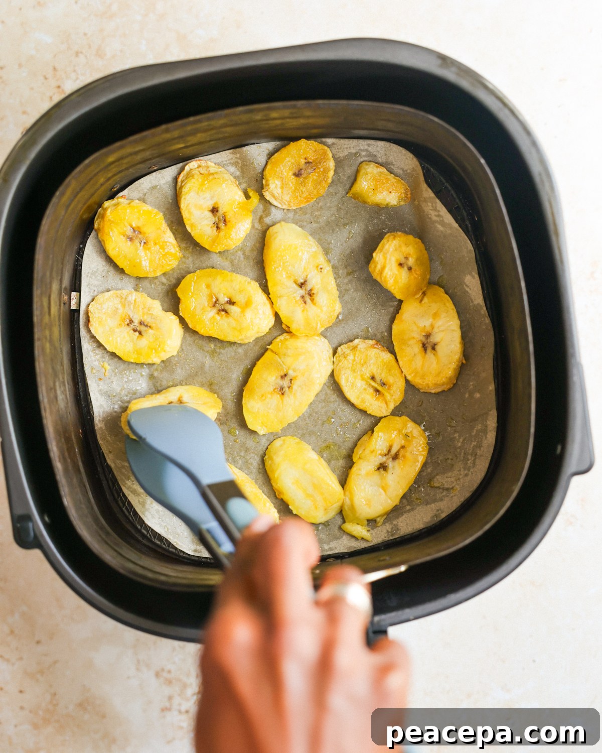 overhead flipping the air fried plantains