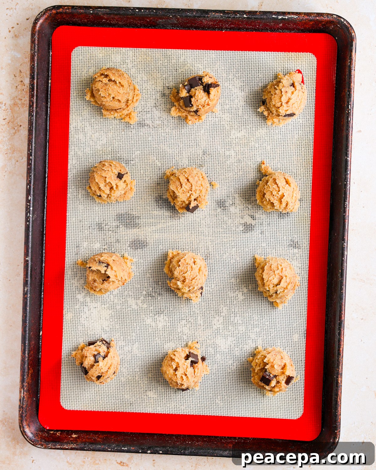 Cookie dough balls on baking sheet.