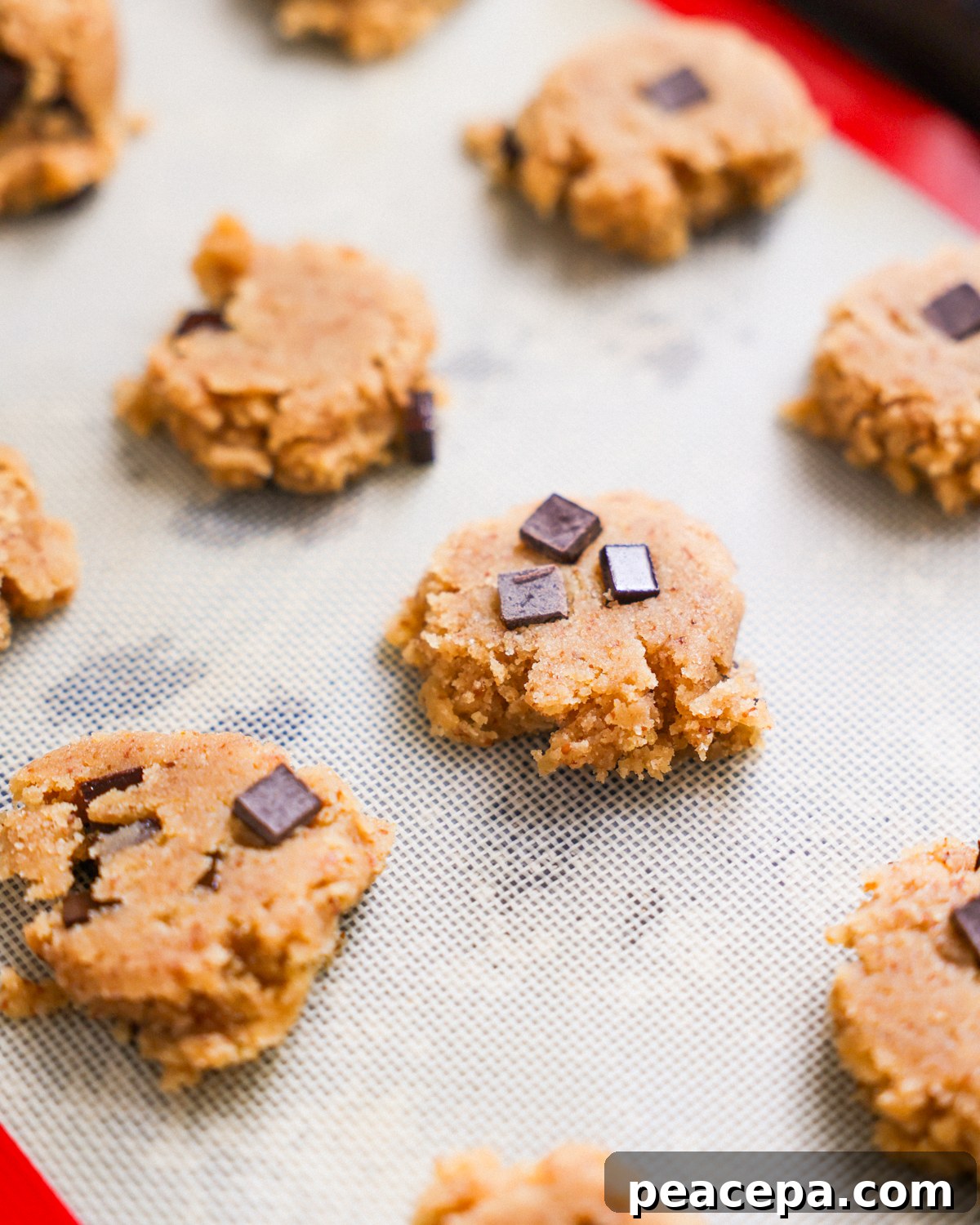 Flattened cookie dough on baking sheet.