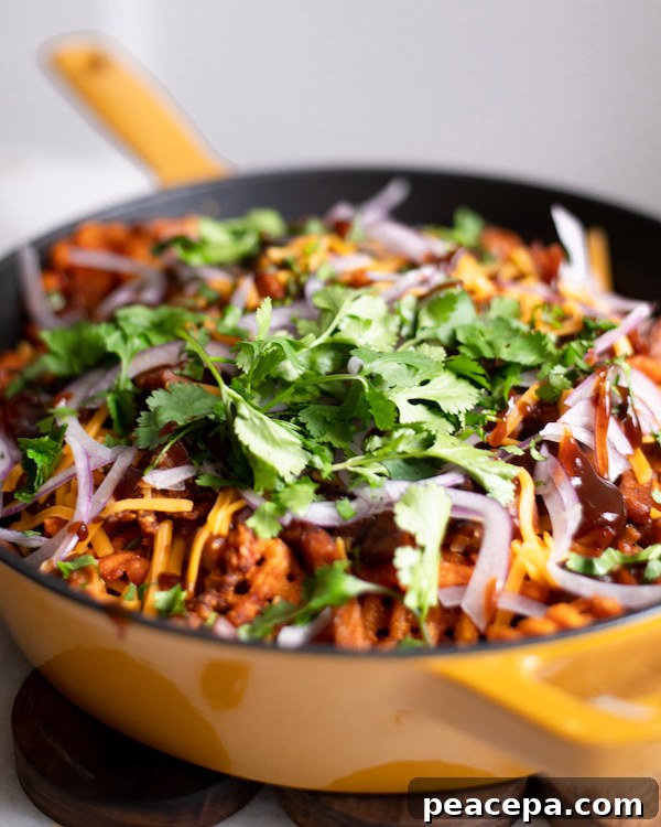 Loaded Sweet Potato Waffle Fries drizzled with vegan bbq sauce.