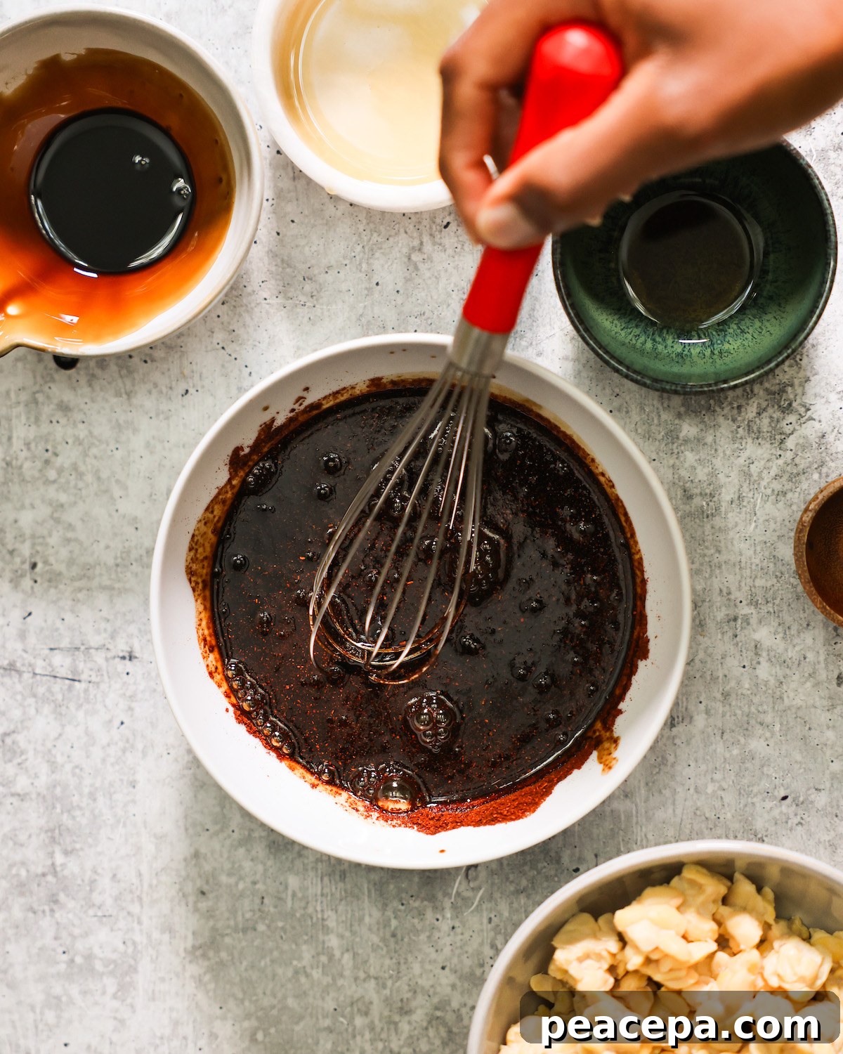 hand whisking marinade for tempeh