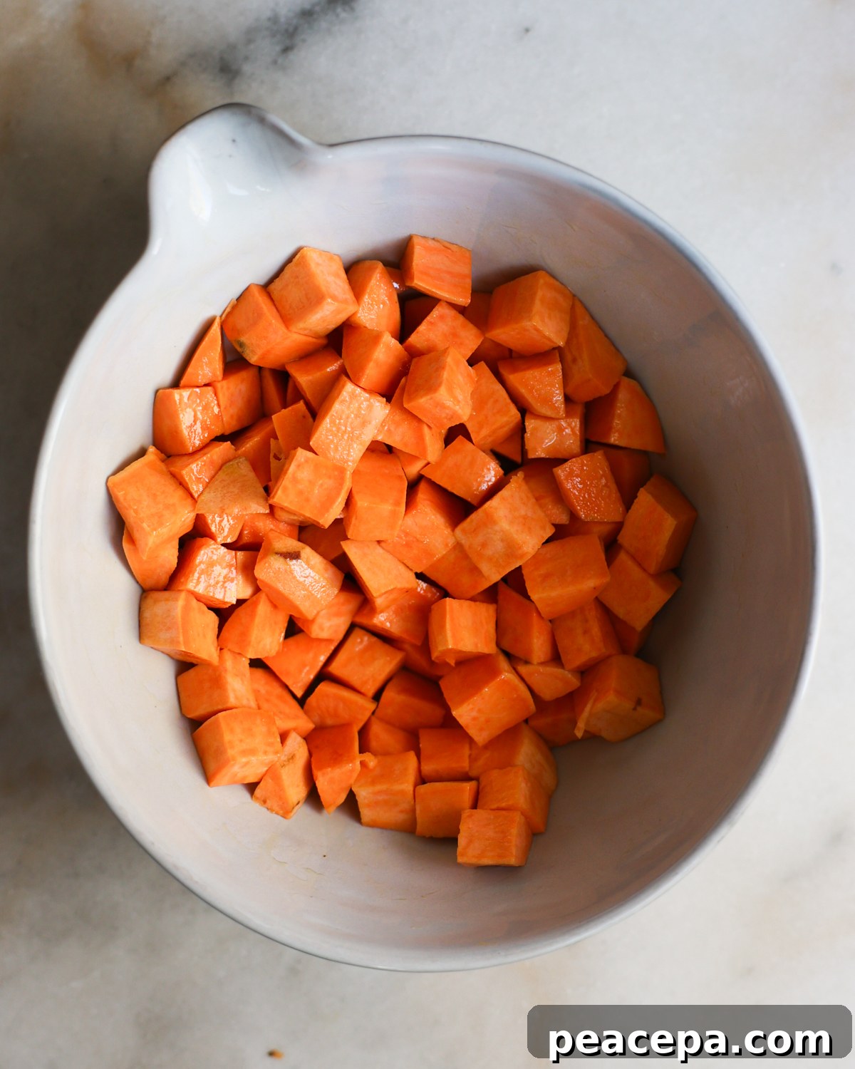 Sweet potato cubes in a mixing bowl.