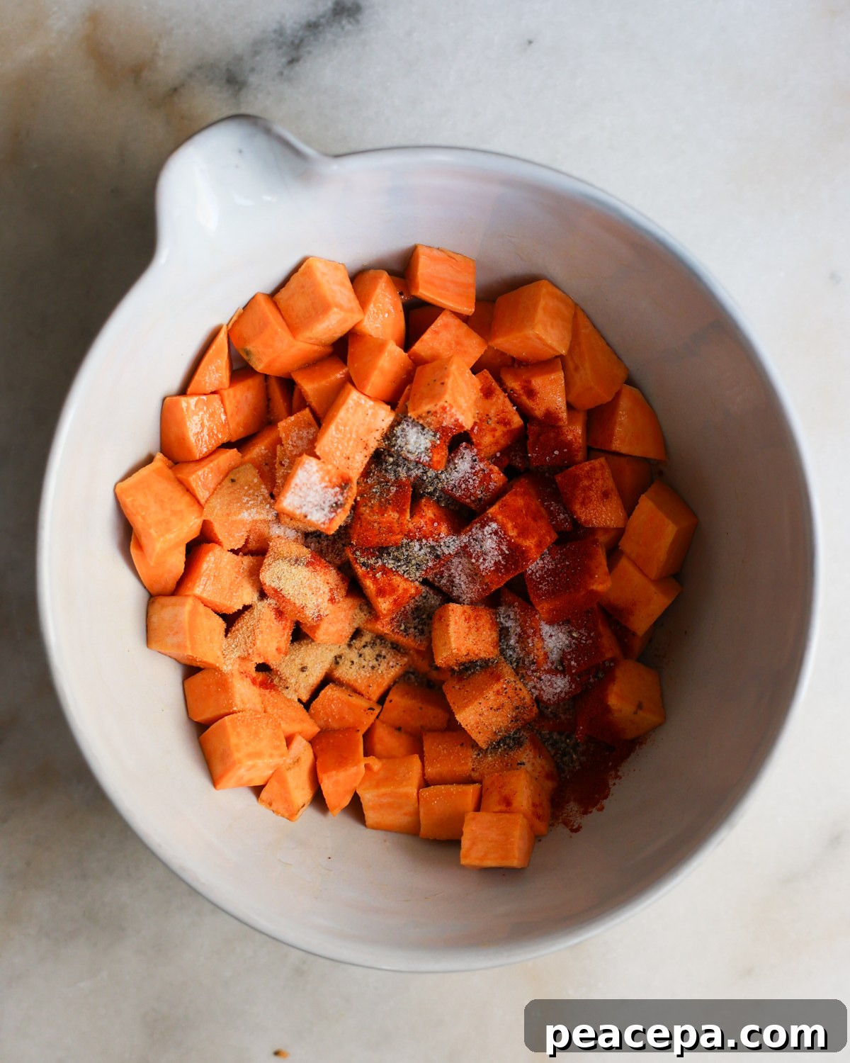 Sweet potato cubes with spices added.
