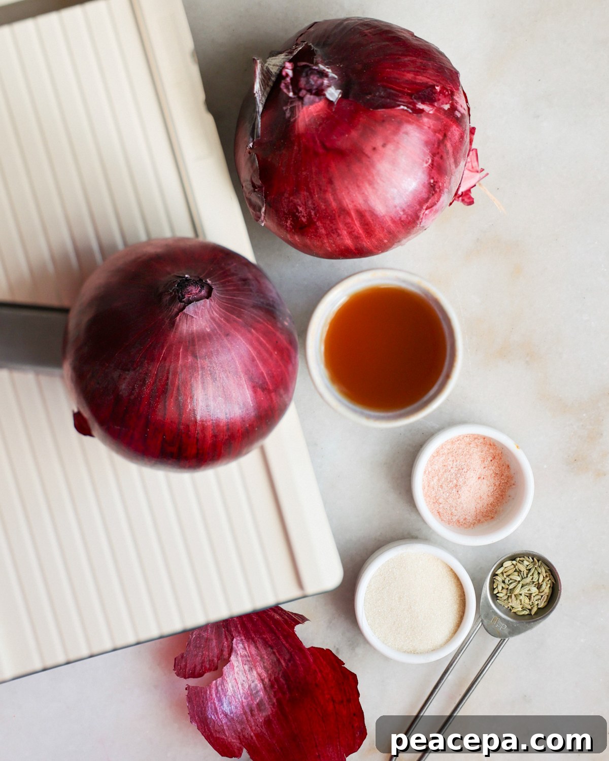 onions and other ingredients with a mandoline on the counter